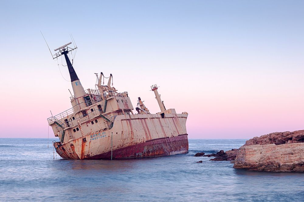 The rusting EDRO III cargo ship aground on the rocks at Peyia near Paphos at sunset